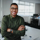 Portrait of young and successful businessman in modern office